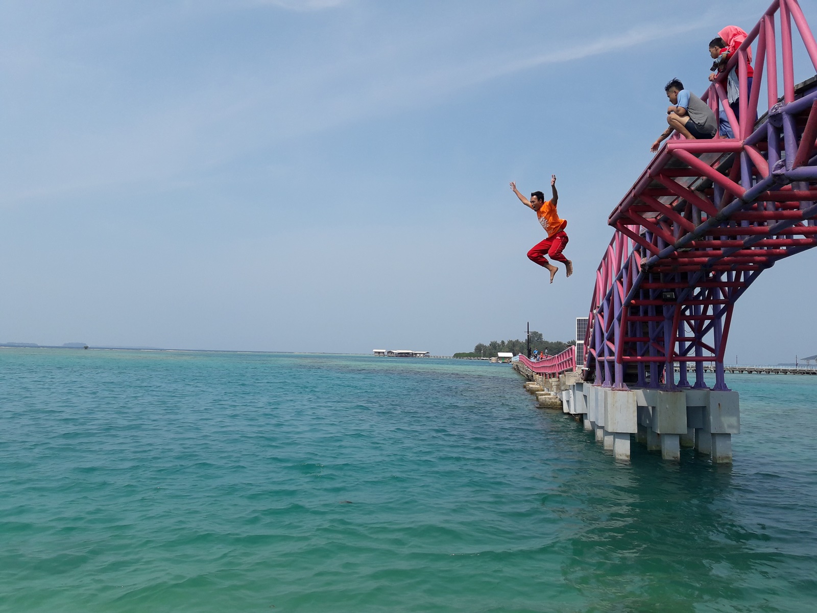 Wisatawan melompat ke laut dari jembatan yang menghubungkan pulau tidung besar dan kecil