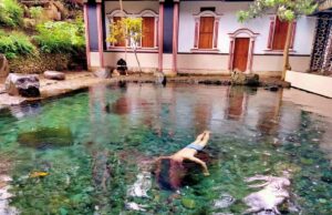 wisatawan sedang berenang di kolam jernih Batu Quran