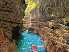 aliran sungai jernih berpagar tebing-tebing di Curug Putri Carita